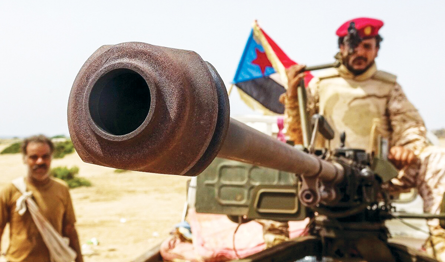 A fighter loyal to Yemen’s separatist Southern Transitional Council (STC) holds the separatist flag in the southern Abyan province. (AFP)