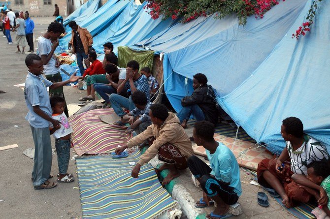 African migrants sit outside tents at a makeshift shelter on June 19, 2014, in the Yemeni capital Sanaa. (File/AFP)