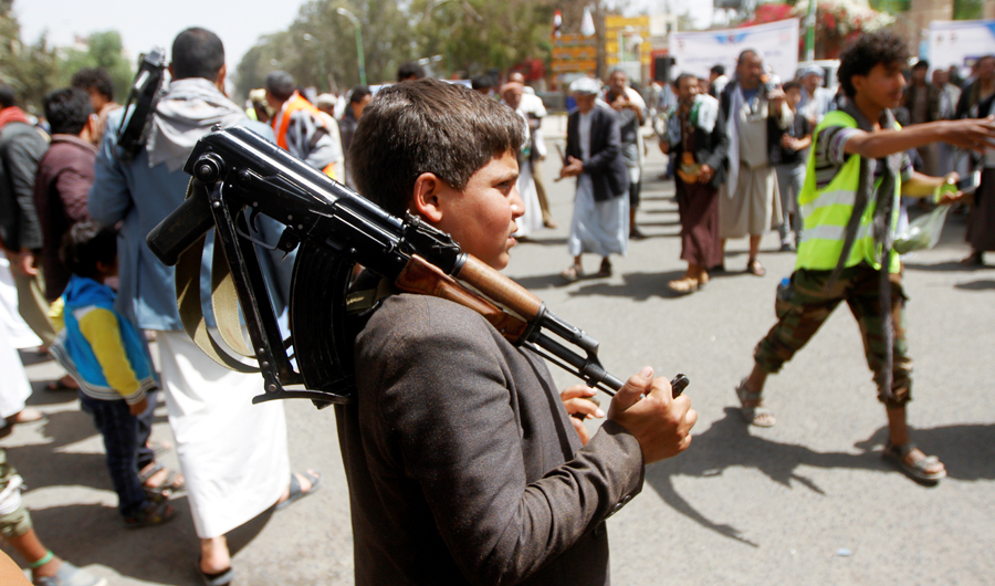 A boy carries a weapon as he and Houthi supporters are seen during a gathering in Sanaa, Yemen. (REUTERS file photo)