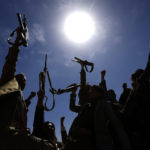 Armed Yemeni men raise their weapons as they gather near the capital Sana'a to show their support to the Shiite Houthi movement against the Saudi-led intervention on February 21, 2019. Mohammed Huwais/AFP via Getty Images)