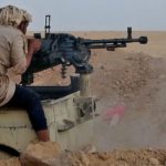 A fighter loyal to Yemen’s internationally recognized government clashes with Houthi rebels on Sunday around the strategic government-held