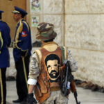 A Houthi follower wears a jacket with a picture of the Houthi-movement founder Housin Badr Al-den Al-Houthi as he comes to participate in a funeral of fighters killed during fighting in Yemen's Marib region, March 23, 2021 in Sanaa, Yemen. (Mohammed Hamoud./Getty Images)