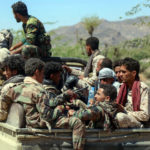 Forces loyal to Yemen's Saudi-backed government sit in the back of a pick-up truck as they deploy during clashes with Houthi rebel fighters west of the country's third-largest city of Taiz, on March 16, 2021. (Ahmad Al-Basha/AFP via Getty Images)
