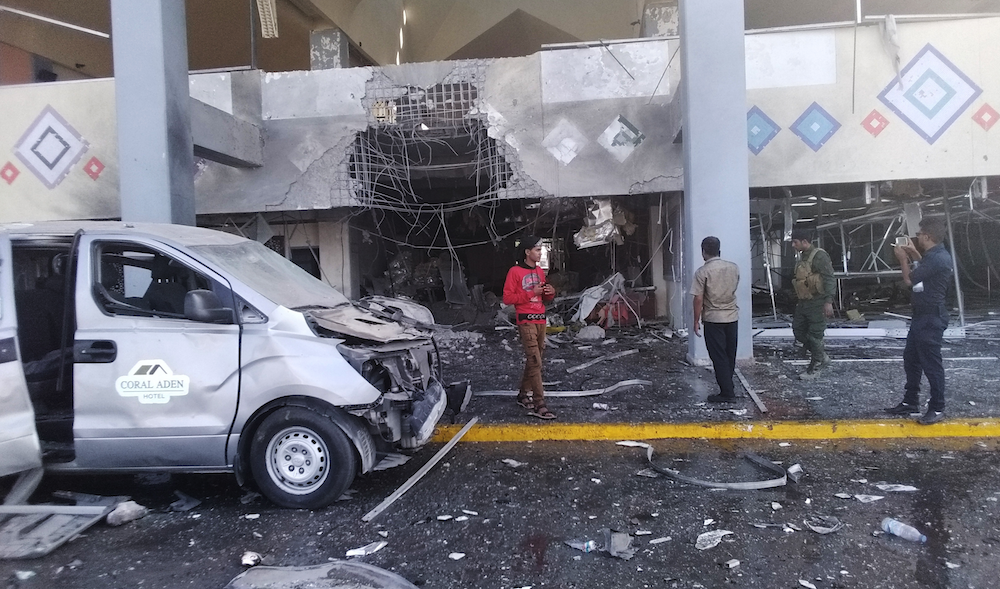 Bystanders and a soldier stand near a damaged portion of the airport of Yemen’s southern city of Aden after an explosion, Wednesday, Dec. 30, 2020. (AP) Bystanders and a soldier stand near a damaged portion of the airport of Yemen’s southern city of Aden after an explosion, Wednesday, Dec. 30, 2020. (AP)